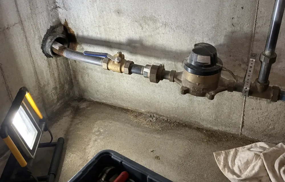 Basement water service entry pipe and main shutoff valve in Chelmsford